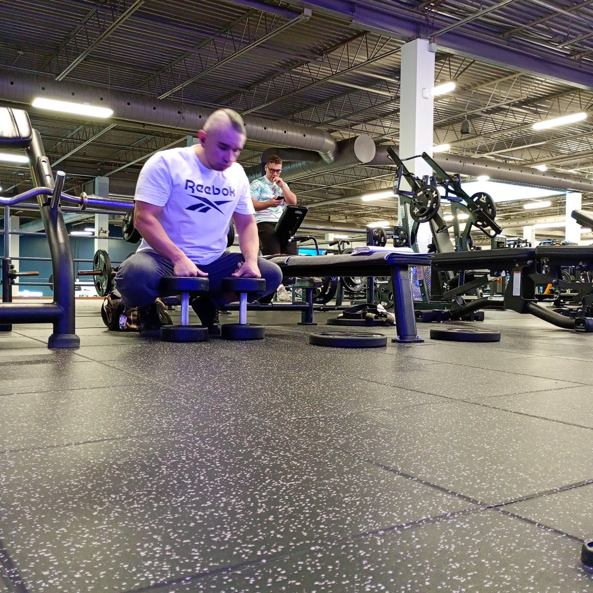 Turf floor training setup near the dumbbell rack